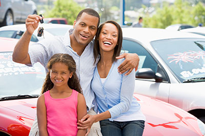 Family in a car posing for the camera