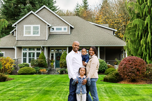 family standing in front of house