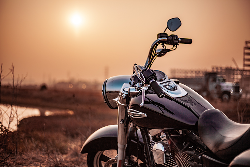 motorcycle next to a sunset