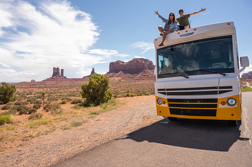 an RV traveling down a dirt road